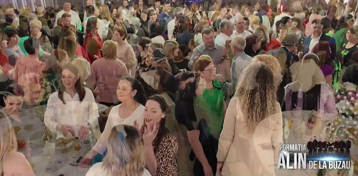Invitați dansând într-o sală de nuntă